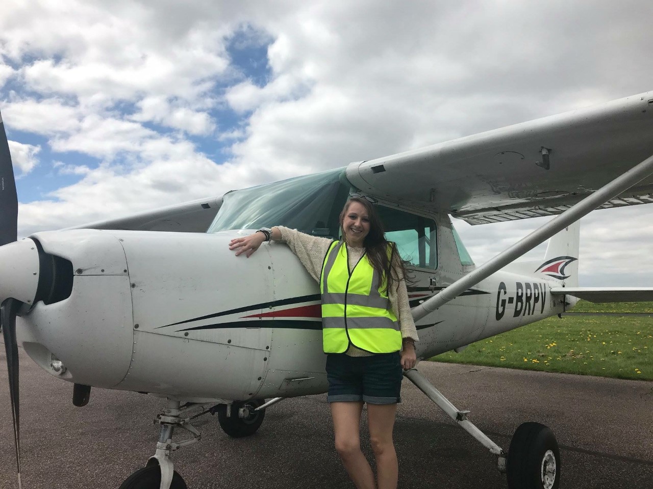 Woman next to aeroplane